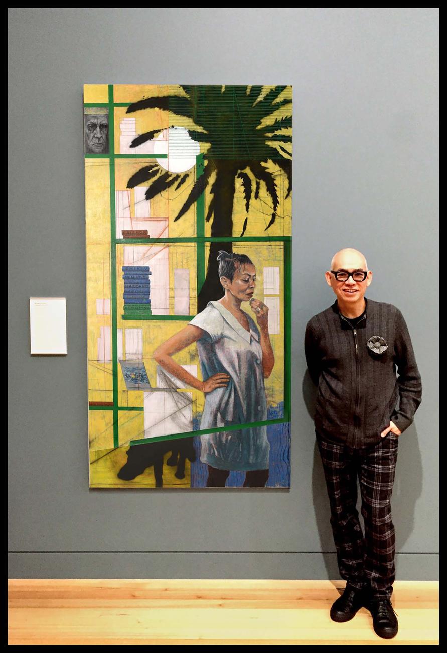 Chong standing beside his portrait of Michelle de Kretser at the National Portrait Gallery